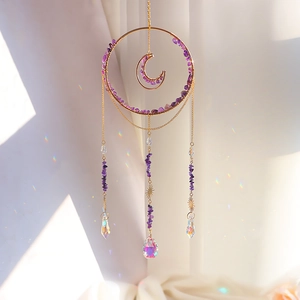 Detail of moon sun catcher with purple crystal chips and prisms for rainbow light effects