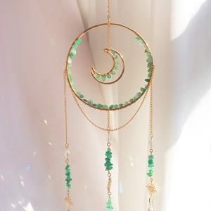 Bohemian sun catcher with moon ring, green crystal stones, and rainbow prism light effect