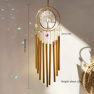 Detail of 9 golden tubes wind chime with crystal prisms creating rainbow light reflections