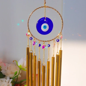 Bohemian 9-tube evil eye wind chime with blue nazar glass and iridescent light reflections