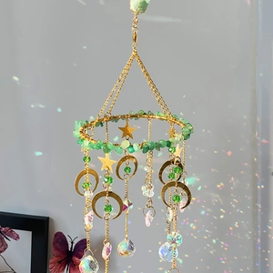 Aventurine suncatcher with gold stars and moon, casting rainbow light on walls