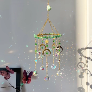 Aventurine moon sun catcher with crystal prisms casting rainbow shadows on wall