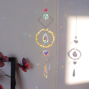 Rainbow light refraction on wall from a geometric crystal suncatcher with natural stones