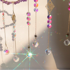 Bohemian suncatcher wind chimes with crystals and gold charms reflecting rainbows