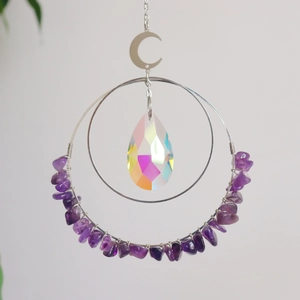 Detailed view of handmade crystal suncatcher with amethyst stones and silver moon pendant