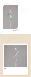 Detail of moon-shaped suncatcher with pink crystals and rainbow prism pendants