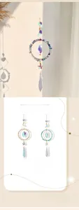Close-up of crystal suncatcher with moon frame and faceted beads showing rainbow light