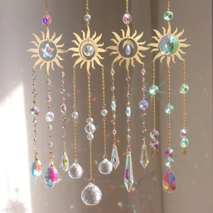 Set of 4 gold suncatchers with metal sun frames and crystal prisms creating rainbows