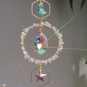 Modern moon-shaped crystal suncatcher with golden metal frame and rainbow prisms