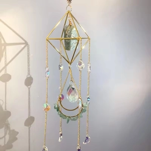 Detailed suncatcher view with golden geometric frame and natural raw crystals