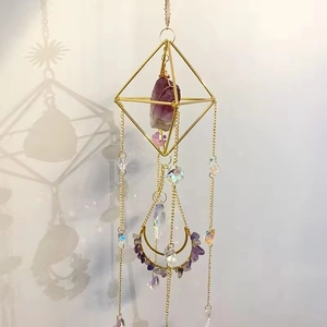 Detail of bohemian geometric amethyst suncatcher with gold octahedron and crystal beads