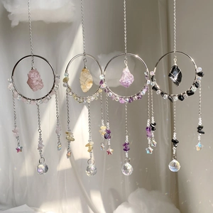 Detail view of crystal suncatchers with natural stones and light refracting prisms