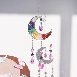 Macro view of handmade moon suncatcher with rainbow stones and faceted crystal prisms