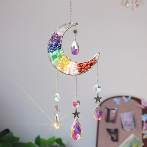 Detail of moon-shaped suncatcher with colorful natural stones and crystal prisms