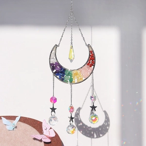 Detail of moon-shaped crystal suncatcher with colorful natural stones and star charms