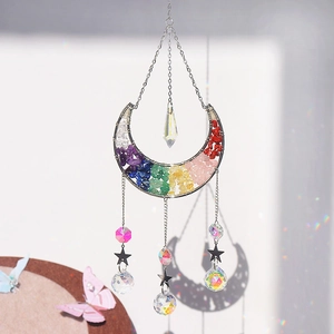 Rainbow crystal moon suncatcher with chakra stones and metal stars on white background
