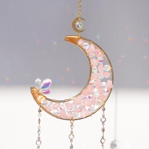 Macro detail of moon-shaped suncatcher with rose quartz stones and rainbow crystal beads