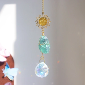 Detail of sun catcher featuring green fluorite stone and crystal ball with rainbow refraction