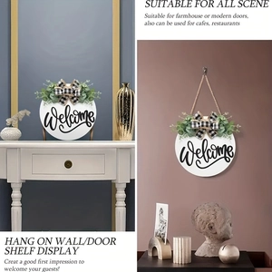 Modern white wooden Welcome sign with eucalyptus greenery and plaid bow on a wall