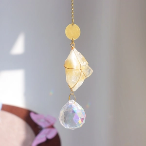 Hanging crystal suncatcher with raw yellow gemstone and faceted ball for rainbow reflections