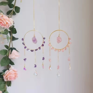 Crystal suncatcher with purple amethyst and rose quartz in gold metal rings hanging decoration