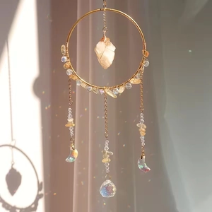 Macro view of crystal suncatcher showing gold ring and rainbow prism light effect