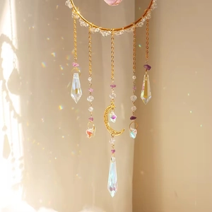 Macro detail of suncatcher showing golden rings, purple stones and crystal prisms