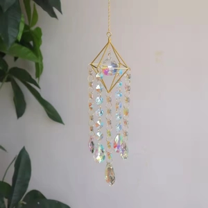 Detail of diamond-shaped metal suncatcher with colorful crystal beads and teardrop pendant