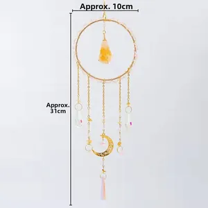 Detail view of crystal suncatcher with golden ring, citrine stone and prisms, approx 31cm long