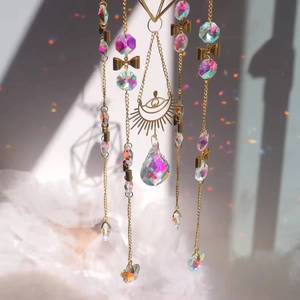 Detail of crystal suncatcher featuring golden butterfly and rainbow sun prism pendant
