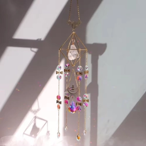 Close-up of bohemian butterfly suncatcher with raw crystal and rainbow light spots