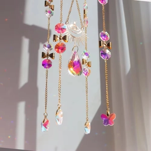 Rainbow crystal suncatcher with golden butterfly chains and teardrop prism pendant
