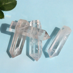 Detailed view of four clear hexagonal crystal pillars with natural internal ice crack texture