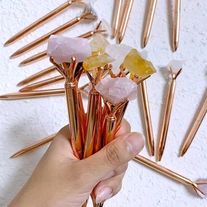 Rose gold ballpoint pens topped with natural raw crystals like quartz and citrine