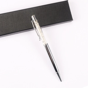 Detailed view of silver crystal ballpoint pen with decorative white stones and elegant gift box