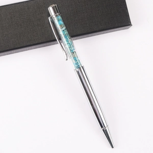 Detailed view of silver crystal ballpoint pen with sky blue crushed stones and gift box
