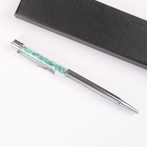 Silver metal ballpoint pen filled with turquoise stones in a black gift box