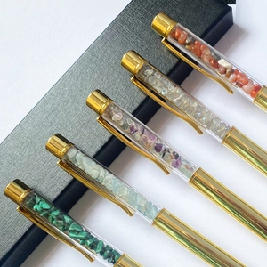 Elegant gold metal ballpoint pens with clear tubes filled with natural crushed crystals