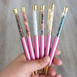 Set of six gemstone crystal ballpoint pens with gold accents held in a fan arrangement