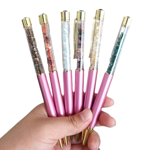 Set of six pink metal ballpoint pens filled with colorful natural crystal gravel stones