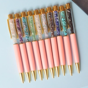 Pink ballpoint pens filled with colorful crystal crushed stones and gold accents