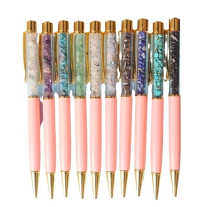 Pink and gold decorative ballpoint pens filled with colorful natural crystal stone chips
