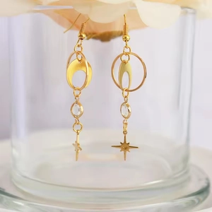 Bohemian gold long drop earrings featuring crescent moon and starburst crystal charms