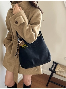 Detailed view of black matte oversized tote bag with cute bear charm for daily commute