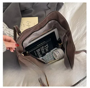 Deep brown tote bag interior showing large capacity for tablet and books with zipper pocket