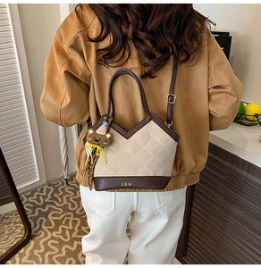 Gewatteerde beige en bruine crossbodytas met metalen logo en schattige berenhanger