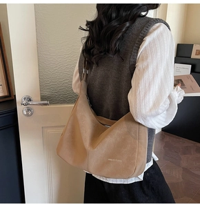 Detail of hobo shoulder bag with a natural vintage leather texture and silver zipper