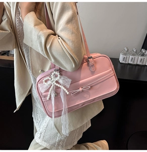 Pink PU leather shoulder bag featuring a pearl lace pendant and bow decoration