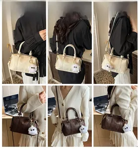 Retro Boston bag with plush charm shown in hand-carry and crossbody styling
