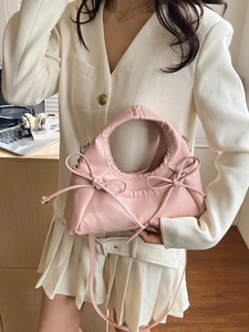 Elegant pink ruched handbag with bow details and shoulder strap for women